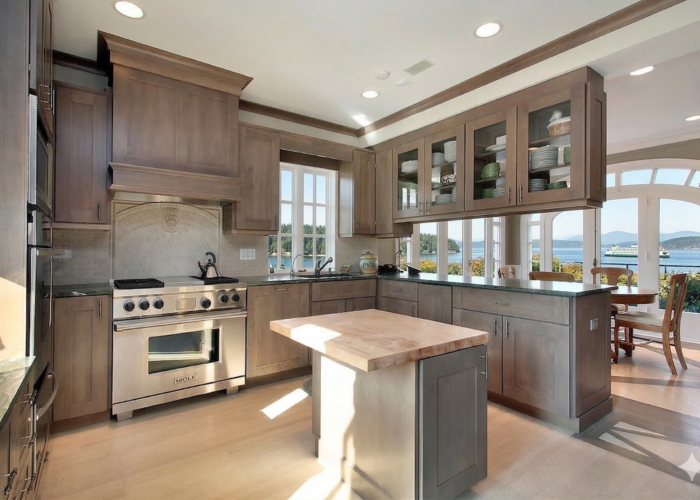 Puget Sound is visible outside the windows of this gorgeous remodeled kitchen.